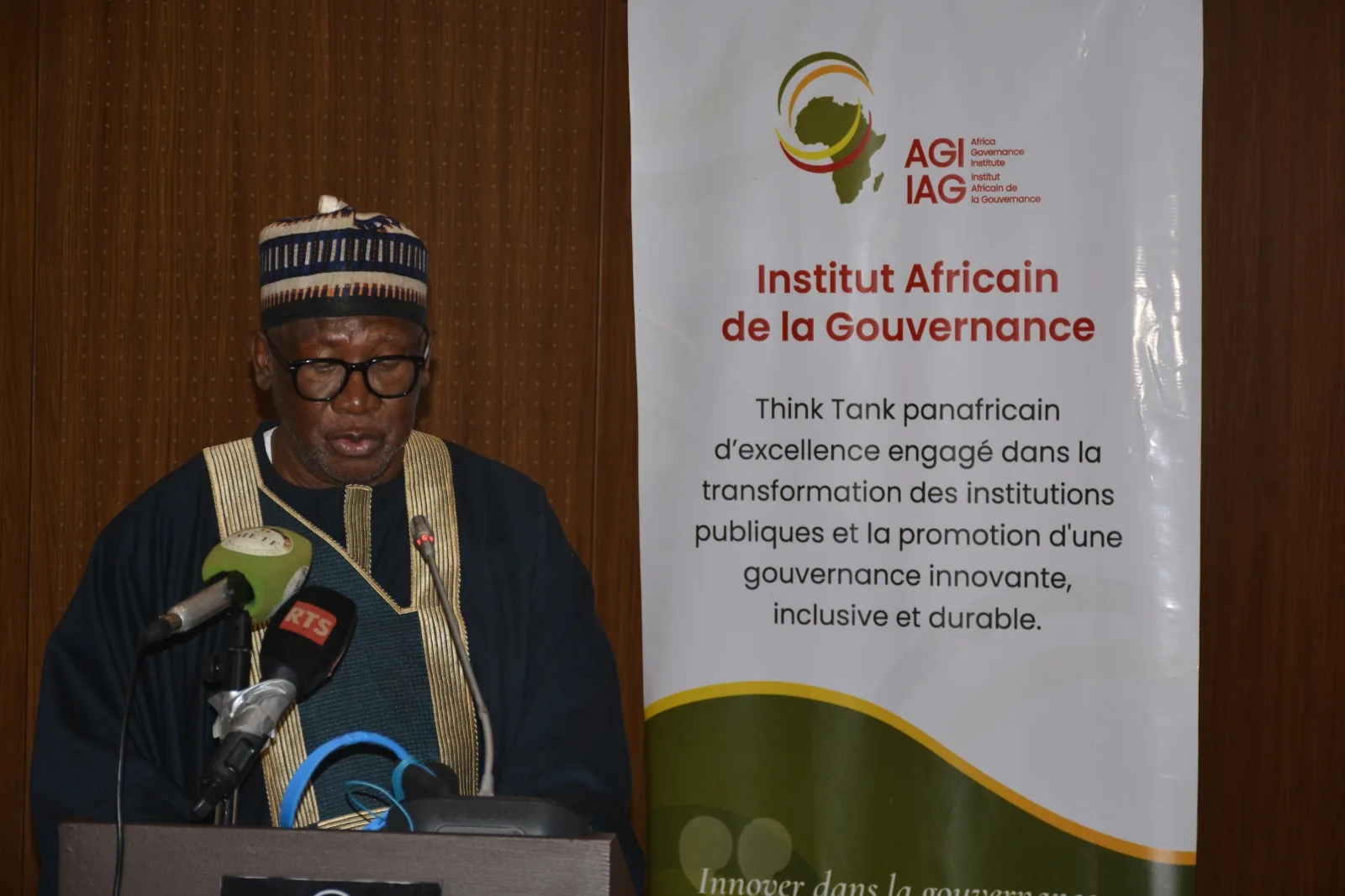 Allocution d'ouverture au pupitre, devant le kakémono de l'Institut Africain de la Gouvernance